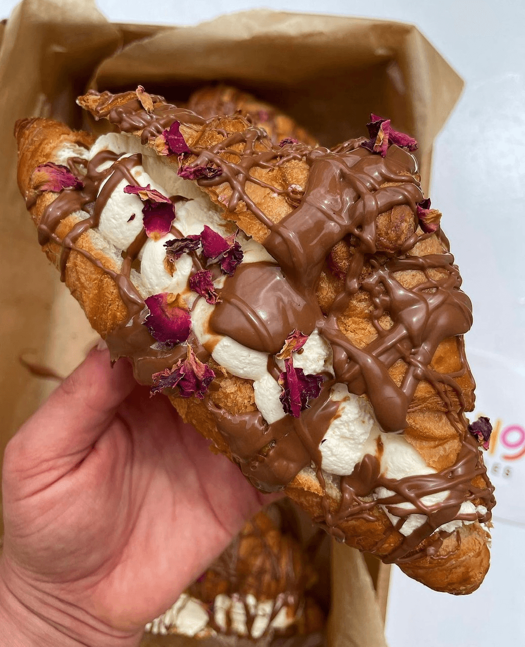 Cream filled croissant with rose petals